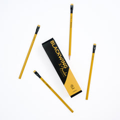 Four yellow pencils with black ferrules and yellow erasers are arranged around a black and yellow rectangular box labeled BLACKWING x Fender on a clean white background.