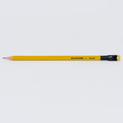 A sharpened yellow Blackwing x Fender pencil with a black ferrule and yellow eraser, shown horizontally against a light background.