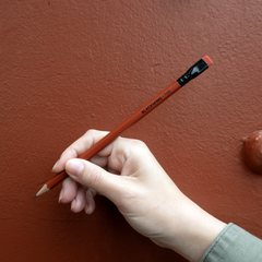 Blackwing Volume 746 pencil, orangeish red barrel, black ferrule, red eraser