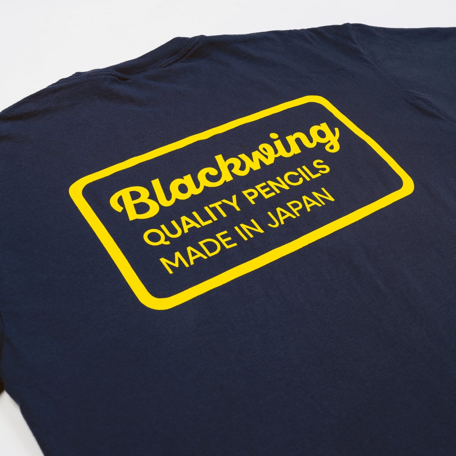 Navy blue 100% cotton t-shirt with yellow "Blackwing, Quality Pencils Made in Japan" text print across upper back.