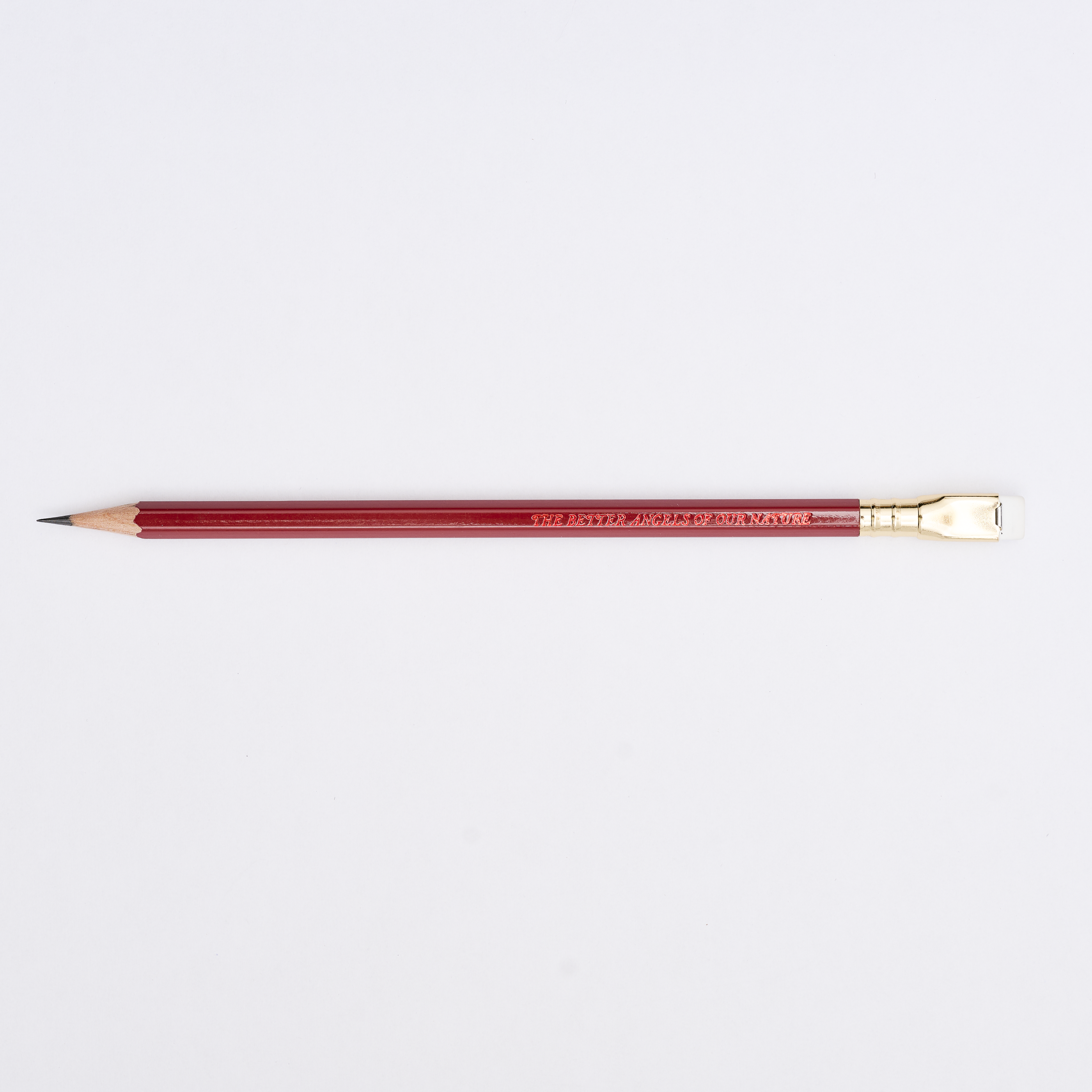 red pencil sharpened on a white background with pencil barrel text 'THE BETTER ANGELS OF OUR NATURE'.