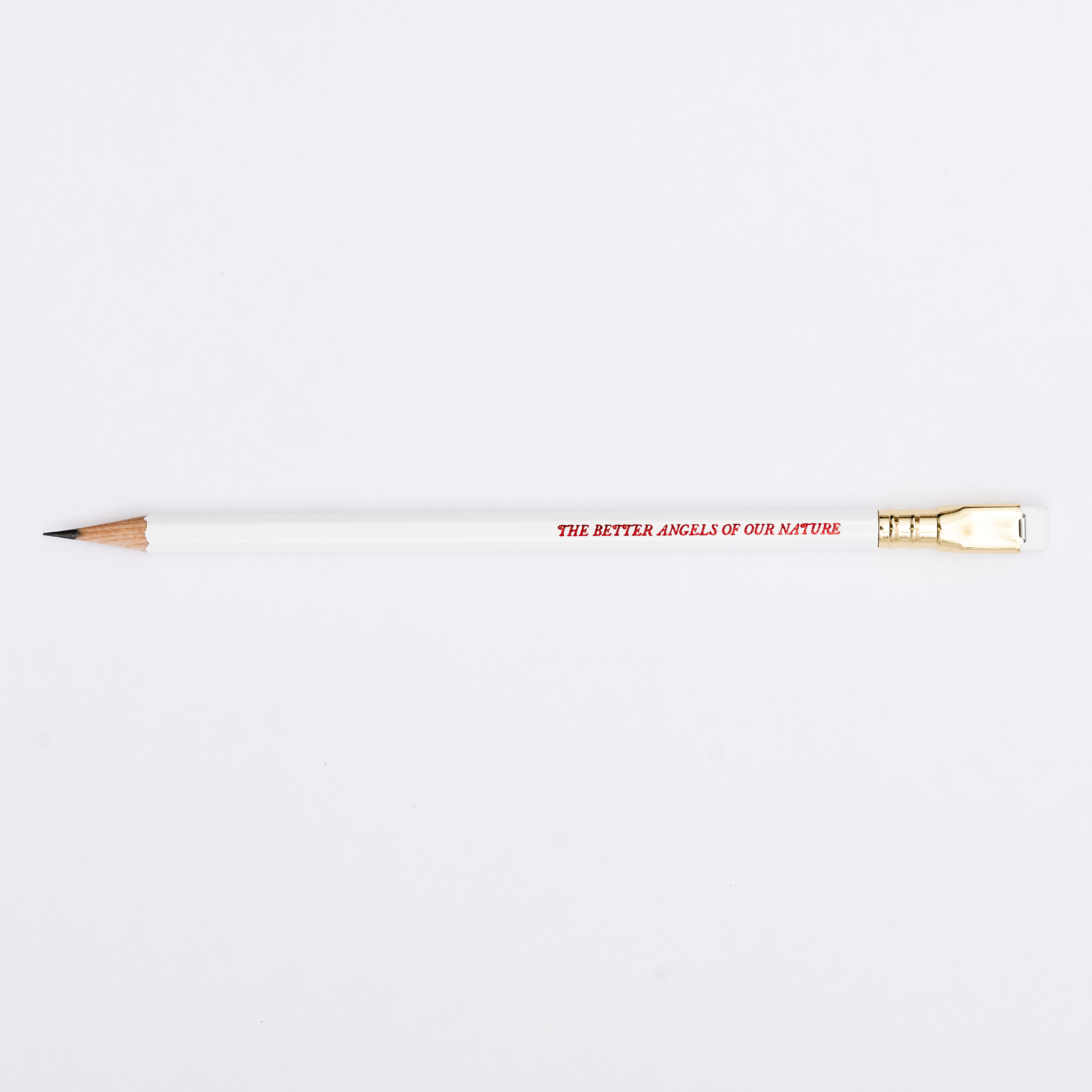 white pencil sharpened on a white background with pencil barrel text in red that says 'THE BETTER ANGELS OF OUR NATURE'.