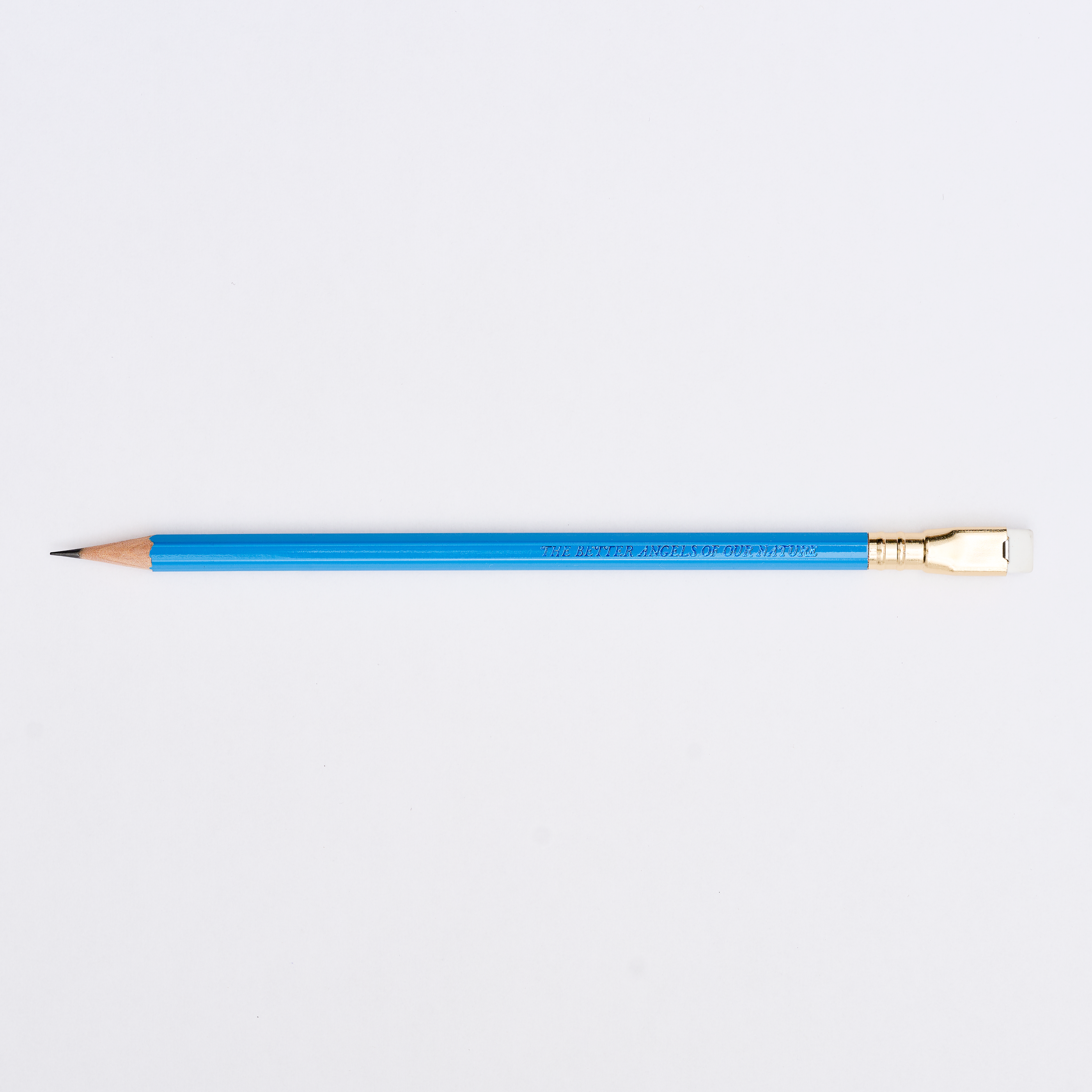 blue pencil sharpened on a white background with pencil barrel text that says 'THE BETTER ANGELS OF OUR NATURE'.