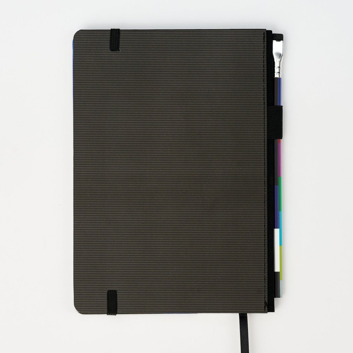 Back of hardcover notebook includes a pencil, on a white background.