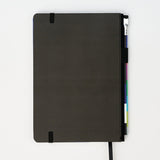 Back of hardcover notebook includes a pencil, on a white background.