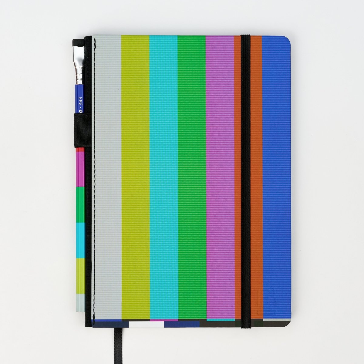 Hardcover notebook with NTSC test pattern, includes a matching pencil, on a white background.