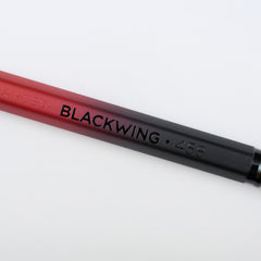 Blackwing Volume 458 pencil with red and black barrel, black imprint, and black ferrule