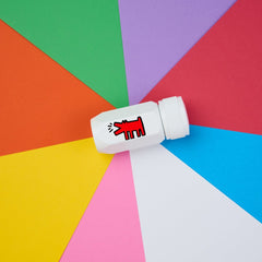 Blackwing Volume 292 One-Step Sharpener in white with Keith Haring's "Dog" illustration in red - seen on a multi-color background