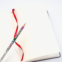 Blackwing Volume 292 - Keith Haring "Tokyo Pop-Shop" Notebook lays open on a table with a Vol. 292 pencil on top