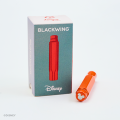 Disney Blackwing red pencil point guard shown next to its blue-gray and white packaging box on a clean white background.